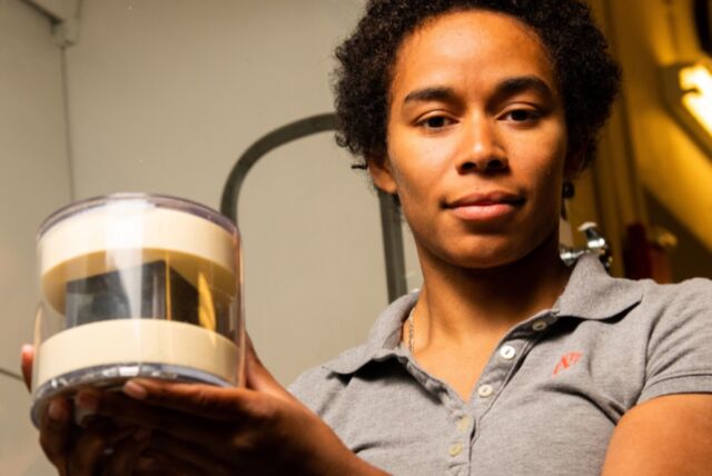 Brittany Robertson with PNNL’s cube, which is in a protective case.