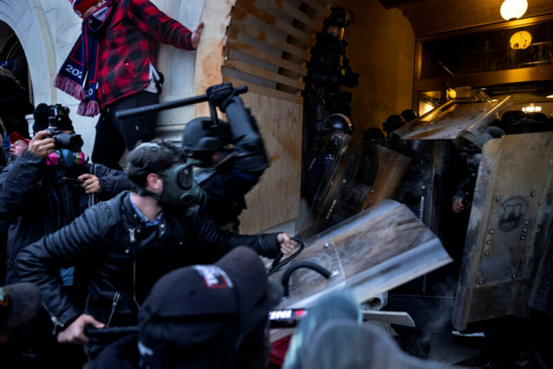 Images of rioters attacking police at the US Capitol.