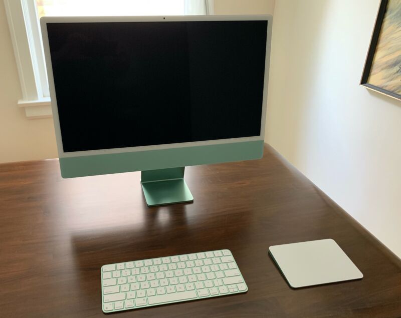 An iMac with a keyboard and trackpad