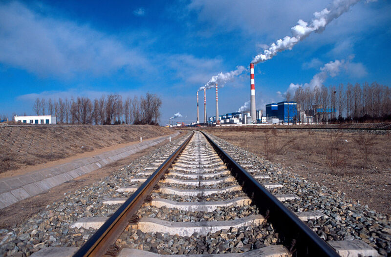 Image of railway tracks leading to a power plant.