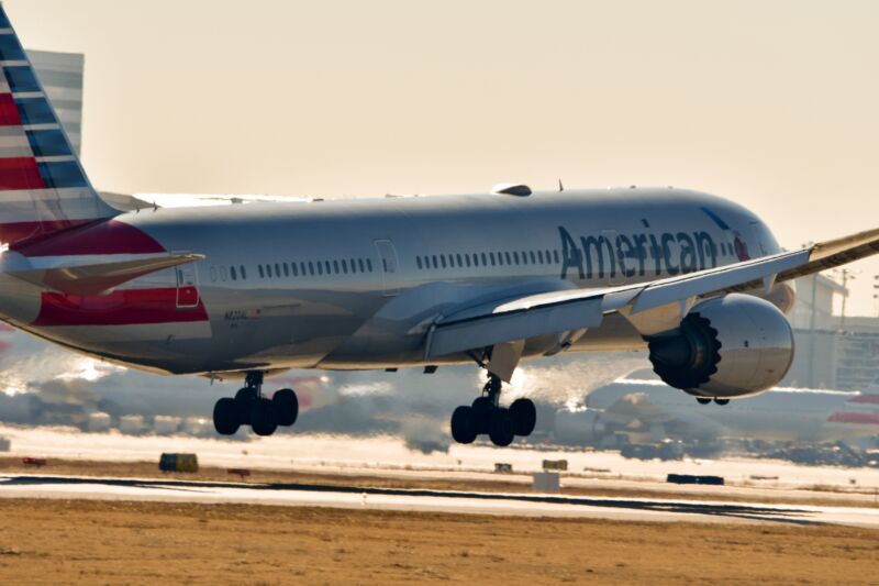 An American Airlines plane landing on a runway at Dallas Fort Worth International Airport.