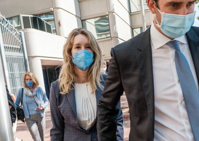 Elizabeth Holmes, founder and former CEO of blood-testing and life sciences company Theranos, leaves the courthouse with her husband, Billy Evans, after the first day of her fraud trial in San Jose, California, on September 8, 2021.