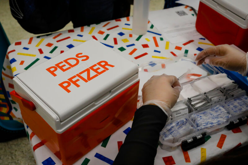 A health care worker prepares to administer Pfizer-BioNTech COVID-19 vaccines at an elementary school vaccination site for children ages 5 to 11.