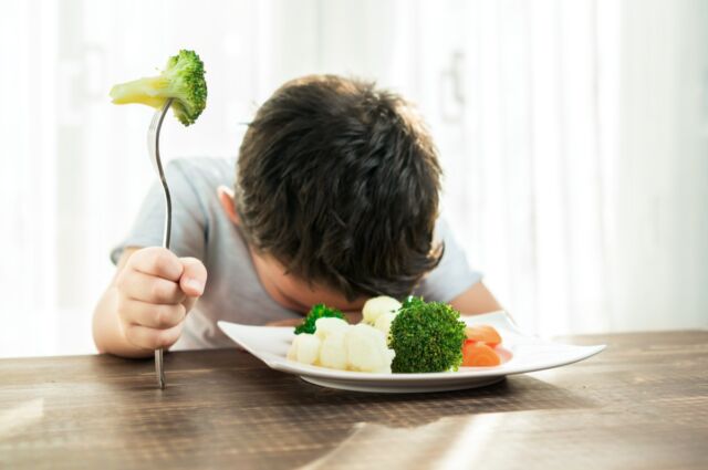 Praying for this plate of bitter-tasting vegetables to magically disappear.