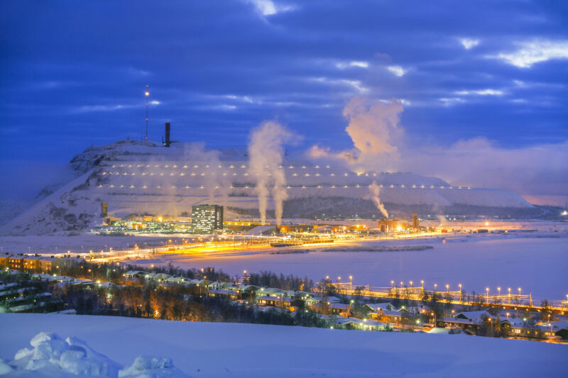 Image of factory like buildings in a snow-covered landscape.