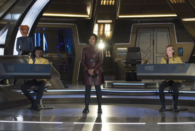 Pictured: Oyin Oladejo as Lt. Joann Owosekun, Sonequa Martin Green as Burnham, and Emily Coutts as Lt. Keyla Detmer of the Paramount+ original series <em>Star Trek: Discovery</em>.”><figcaption class=