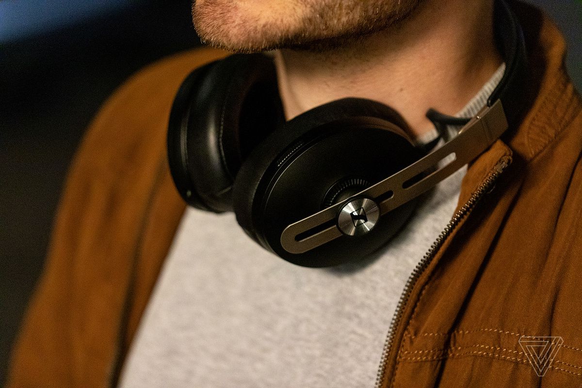 A photo of Sennheiser’s Momentum Wireless 3 headphones, the best noise-canceling headphones for sound quality, worn around someone’s neck.