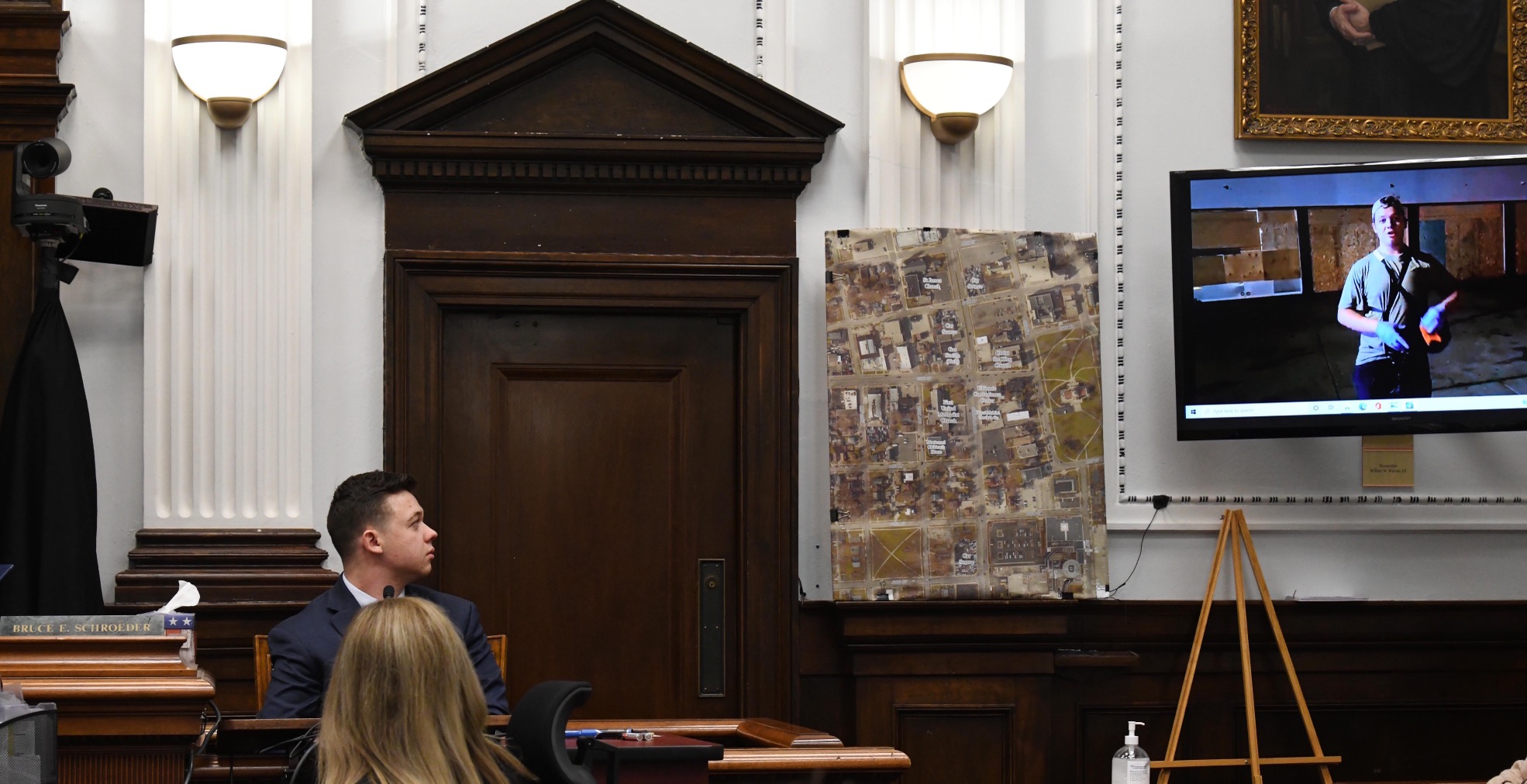 Kyle Rittenhouse watches video of himself from the night of the shootings during cross-examination at the Kenosha County Courthouse on November 10, 2021, in Kenosha, Wisconsin.