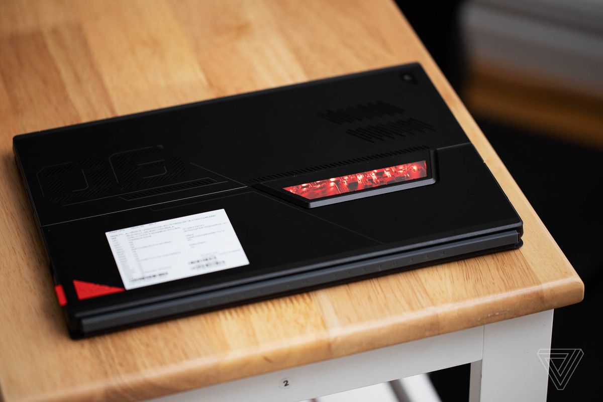 The Asus ROG Flow Z13 closed, upside-down, seen from above on a wooden table.