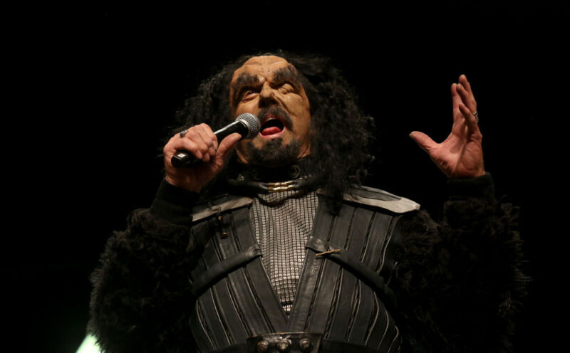 Actor J.G. Hertzler, dressed as his character Martok from the <em>Star Trek</em> television franchise speaks during the "STLV19 Klingon Kick-Off" panel at the 18th annual Official Star Trek Convention at the Rio Hotel & Casino on July 31, 2019 in Las Vegas, Nevada.”><figcaption class=