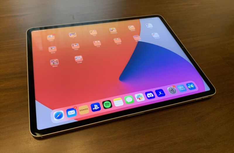 Tablet computing device on a wooden table.