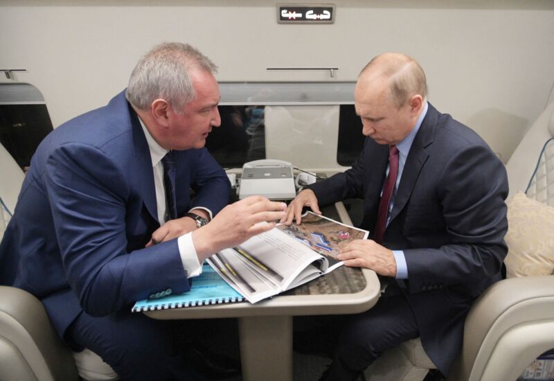 Russian President Vladimir Putin speaks with head of Russian space agency Roscosmos Dmitry Rogozin during a flight to the Vostochny Cosmodrome on September 4, 2021.