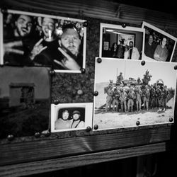 <em>A collection of photographs on the wall of Brown’s van, including one from his deployment in Iraq.</em>“></noscript> </a> <span class=