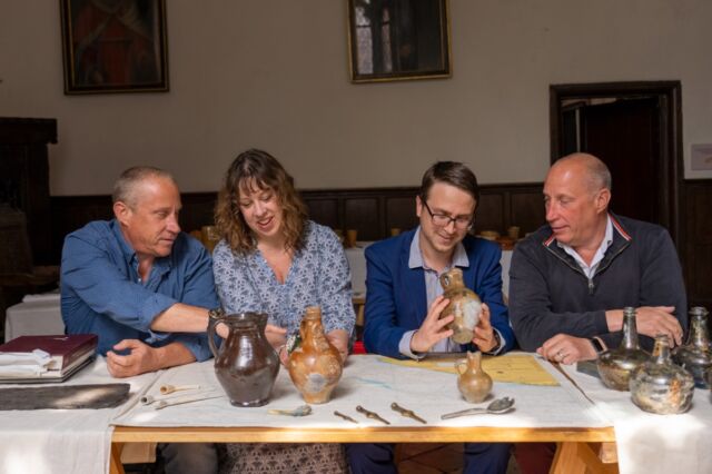 (L-R) Lincoln Barnwell, Claire Jowitt (UEA), Benjamin Redding (UEA), and Julian Barnwell look at some of the items found in the shipwreck.