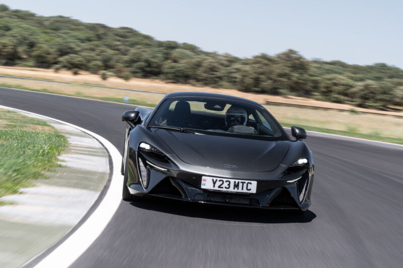 A metallic grey McLaren Artura drives towards the camera