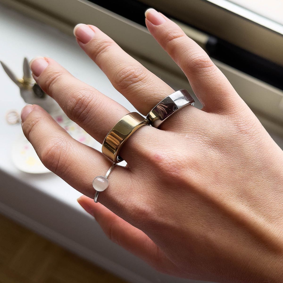 A normal ring, the Oura Ring Gen 3 (center), and the Oura Ring Gen 2 (left)