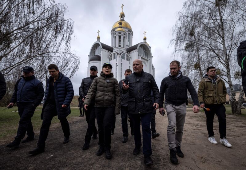 Ukraine's Prosecutor General Iryna Venediktova (C-L) and Prosecutor of the International Criminal Court, Britain's Karim Khan (C-R), visit a mass grave on the grounds of the Church of Saint Andrew in Bucha, on the outskirts of Kyiv, on April 13, 2022.