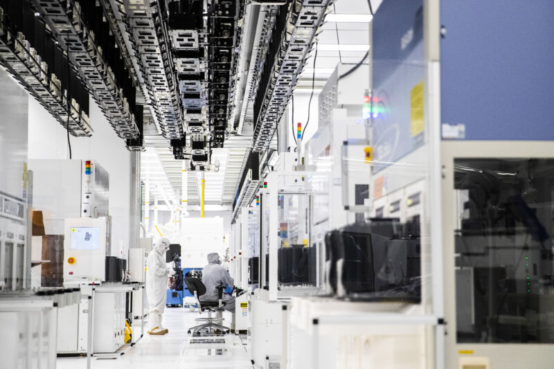 Employees wearing cleanroom suits monitor chemical vapor deposition operations inside the GlobalFoundries semiconductor manufacturing facility in Malta, New York. Production plants for semiconductors have become a focal point as the economic recovery from the pandemic is held back in areas by a shortage of some of the critical electronic components necessary.