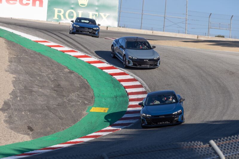 Three Audi RS e-tron GTs going through the corkscrew at Laguna Seca