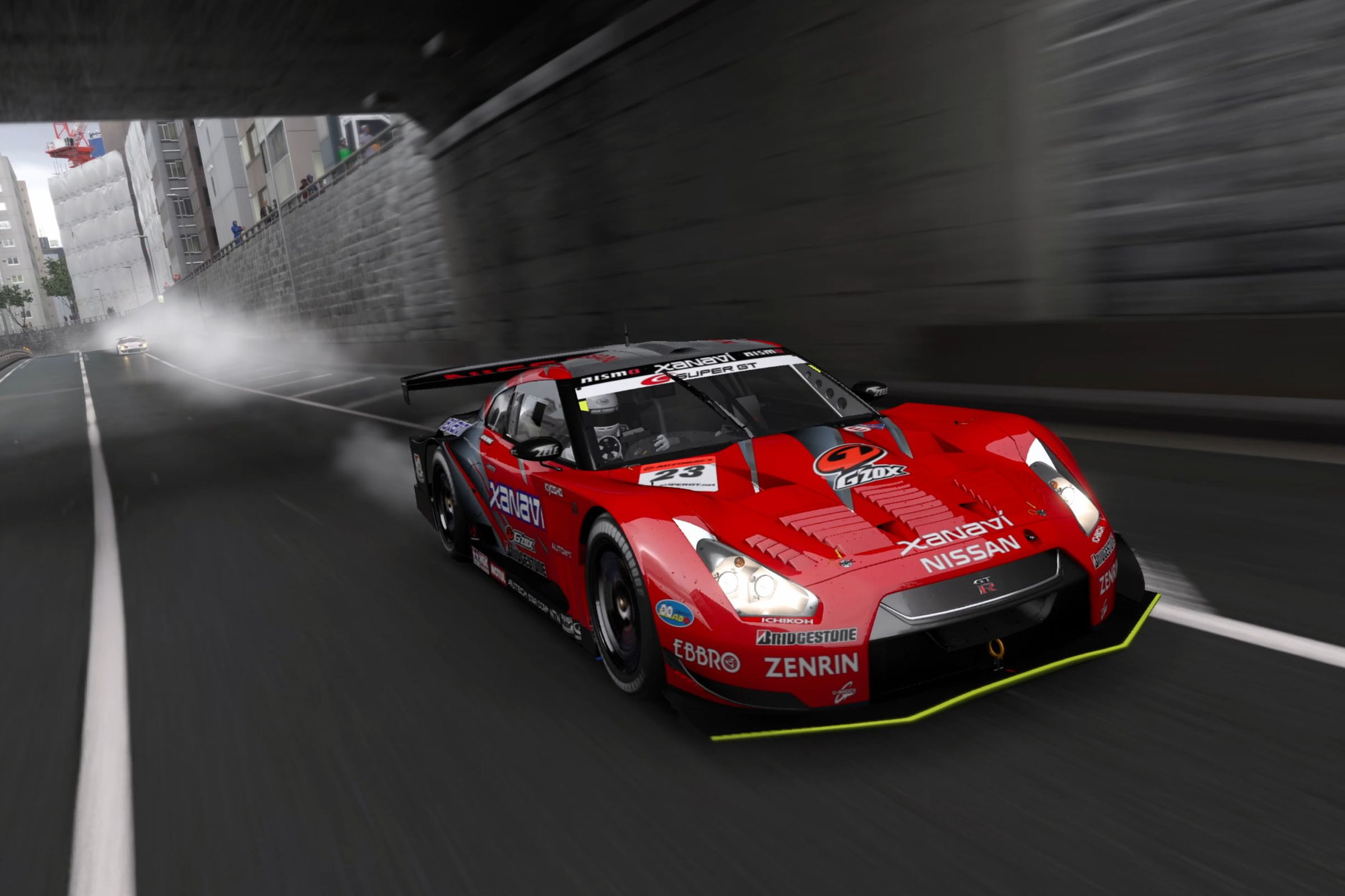 A red Nissan sportscar enters a city tunnel.