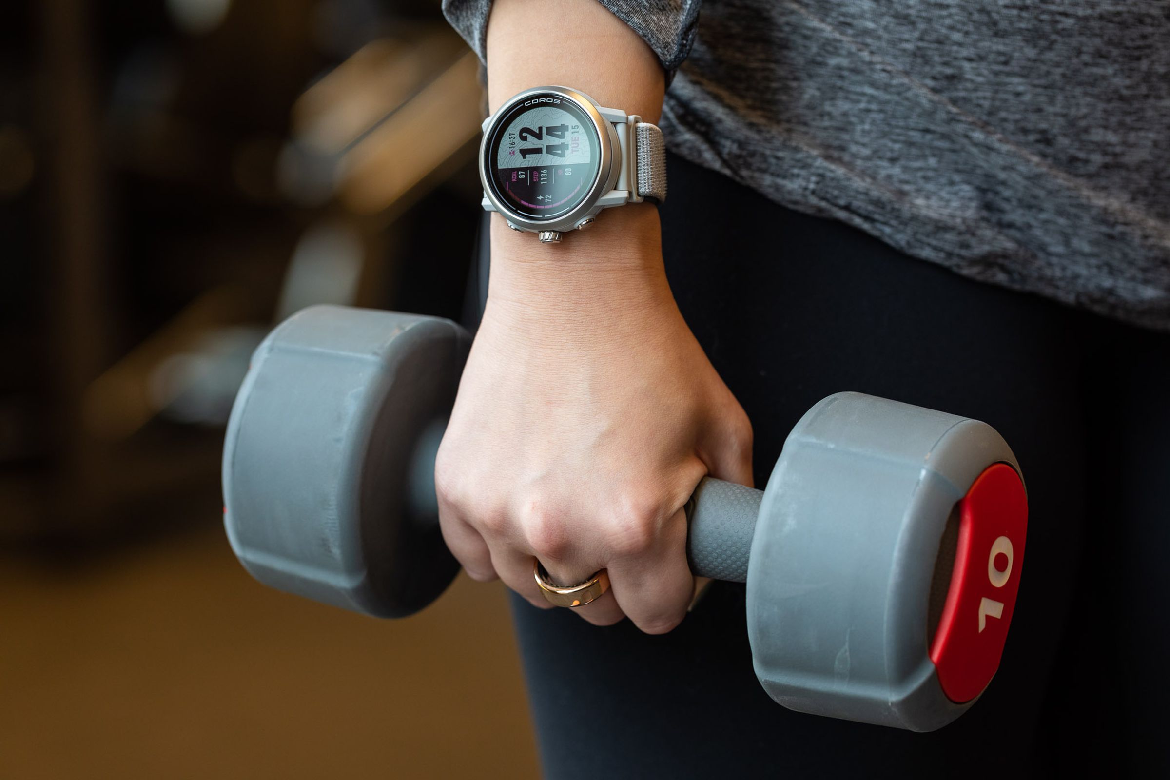 Person wearing Apex 2 while holding a dumbbell