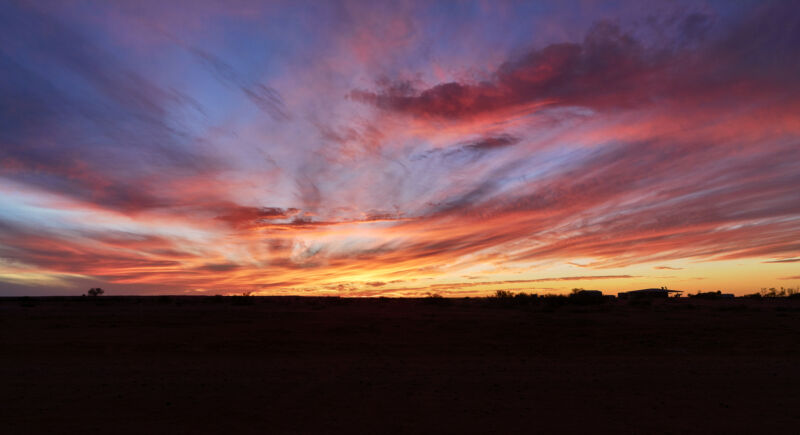 Image of clouds bathed in orange and pink light.