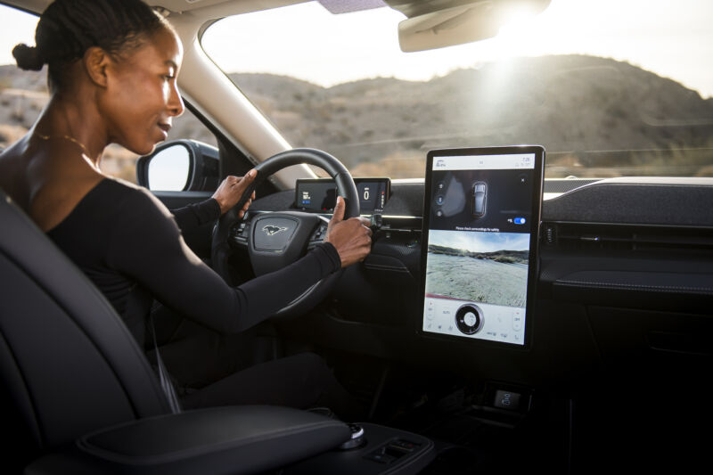 A person looks at the infotainment screen in a Ford Mustang Mach-E