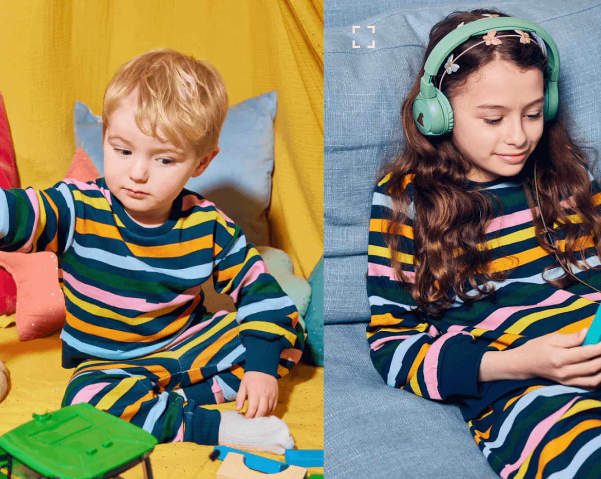 Two kids wearing matching colorful tracksuits