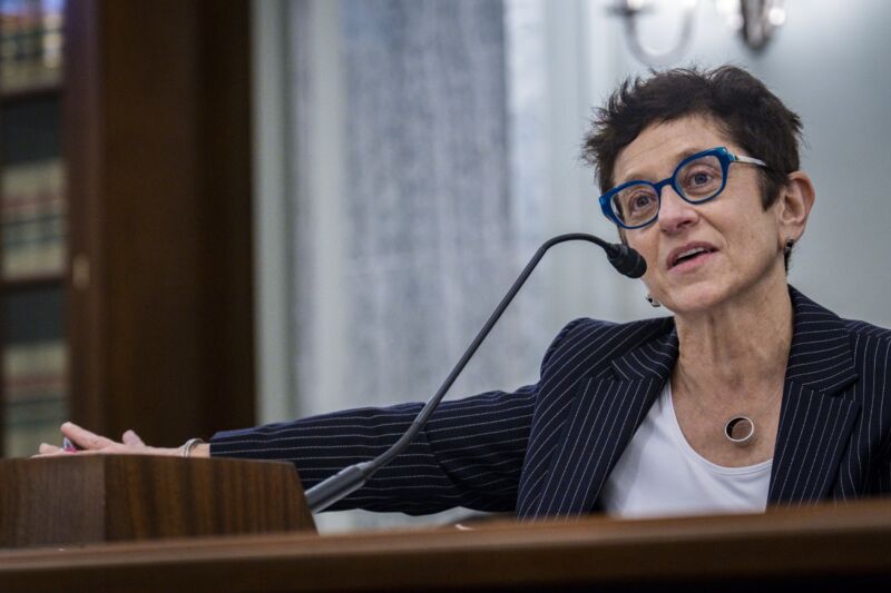 Gigi Sohn speaking into a microphone while seated during a Senate hearing.