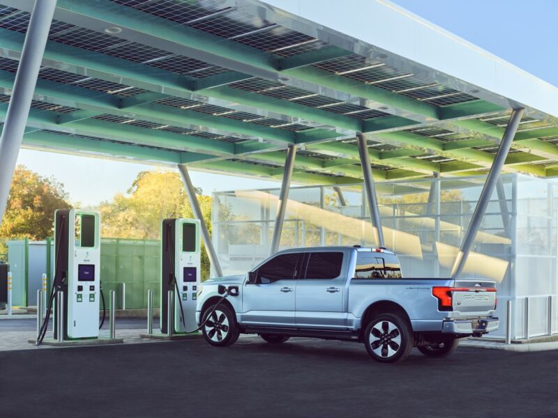 A ford F-150 lightning charges at an EA station