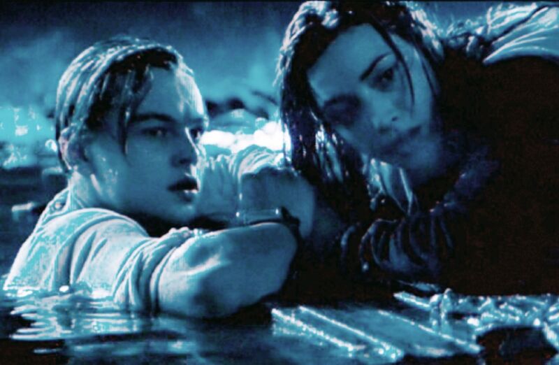 Jack (Leonardo DiCaprio) sacrifices his spot on a makeshift raft to save Rose (Kate Winslet) in <em>Titanic</em>.”><figcaption class=