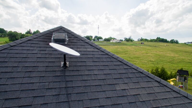 The original round version of the Starlink satellite dish mounted on a roof..