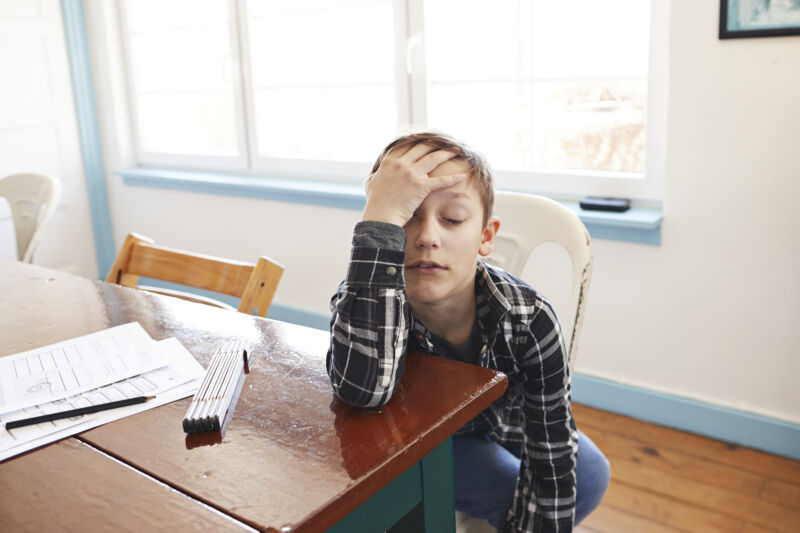 Image of a child looking extremely bored and unhappy