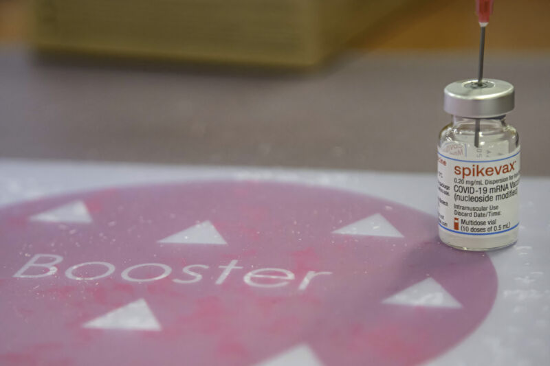 A vial containing Moderna COVID-19 booster vaccine at a vaccination center.