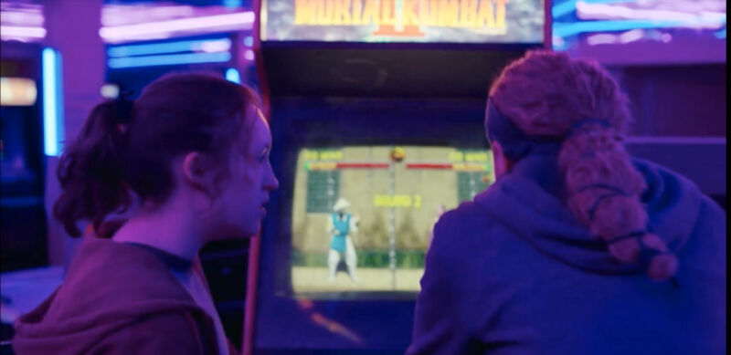 It took a lot of work for Ellie and Riley to play <em>Mortal Kombat II</em> in <em>The Last of Us</em>—and somehow just as much work, if not more, to be able to film it.”><figcaption class=