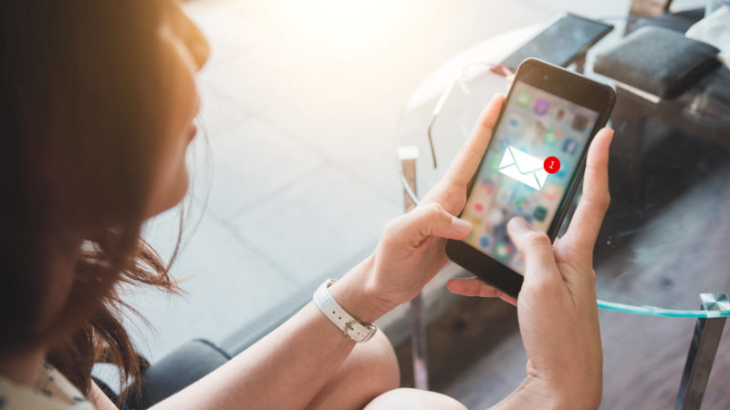 woman reading email on smartphone