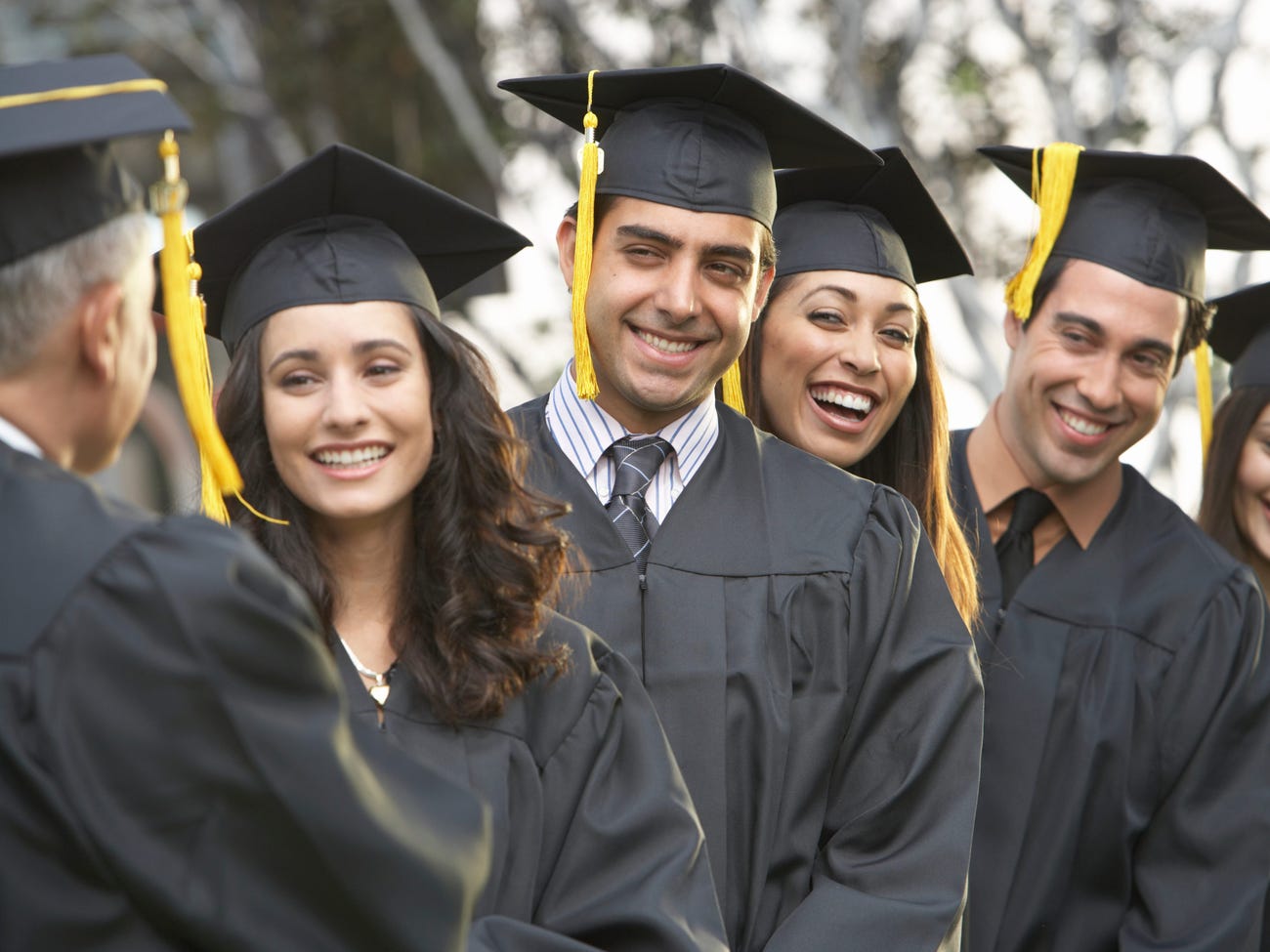 Graduate students standing in a row, outdoors