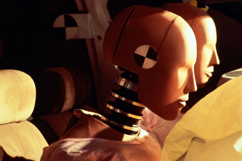 Crash test dummy heads about to hit airbags