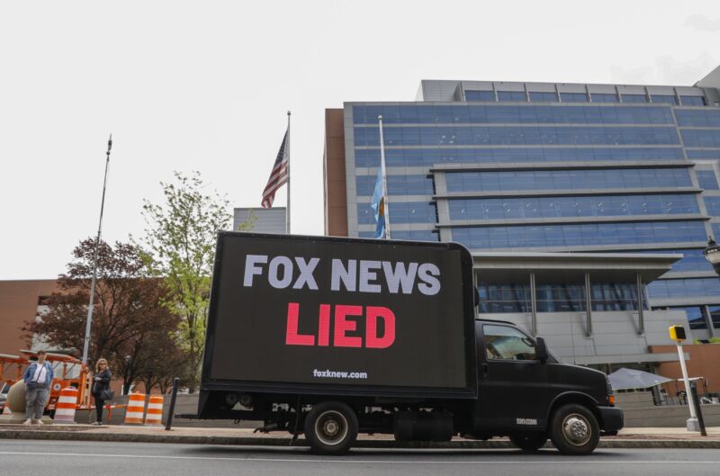 A truck with a giant sign that says 