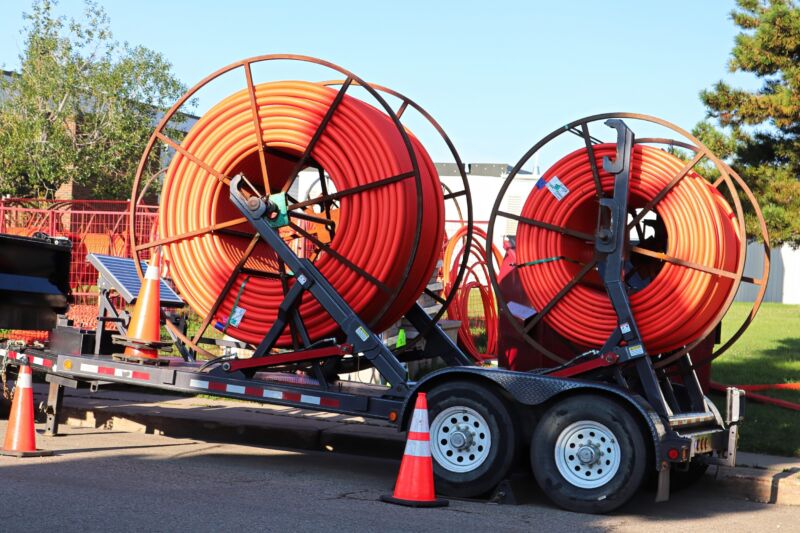 Two large spools of fiber conduits, which are used to install fiber cables underground.