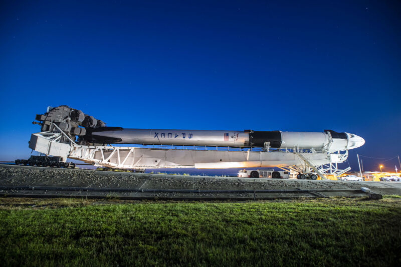 SpaceX rolls a Falcon 9 rocket to the launch pad at Kennedy Space Center for the Axiom-2 mission.