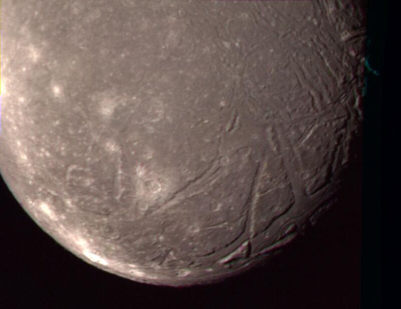 The complex terrain of Ariel is viewed in this image, the best Voyager 2 color picture of the Uranian moon.