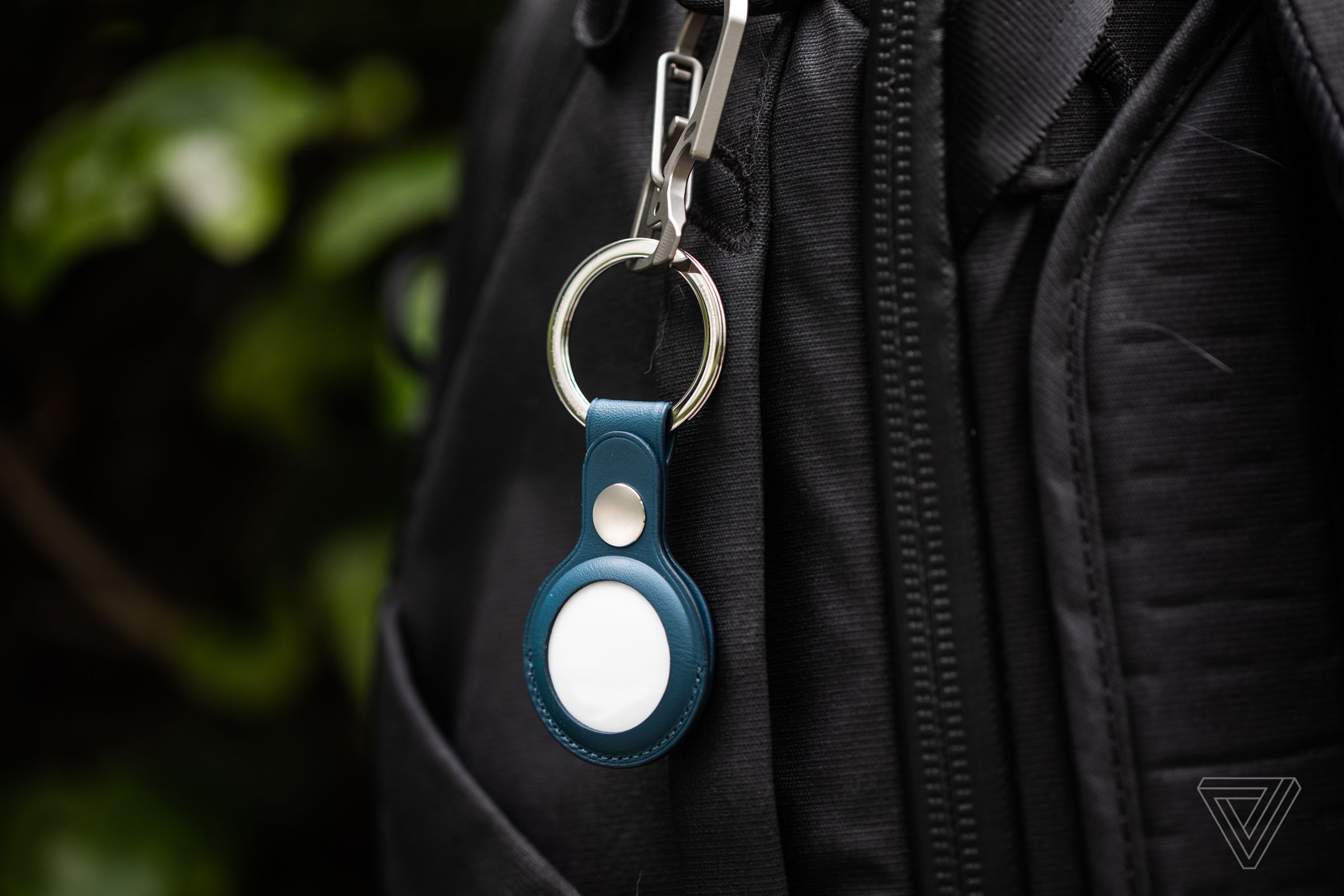 An AirTag in an Apple keychain accessory