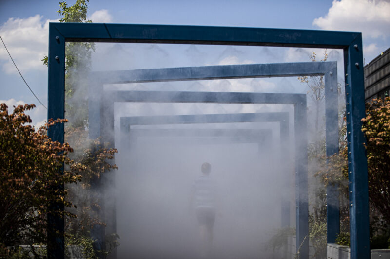 A tourist refreshes at a vapor barrier in Budapest, Hungary, on July 16, 2023. 