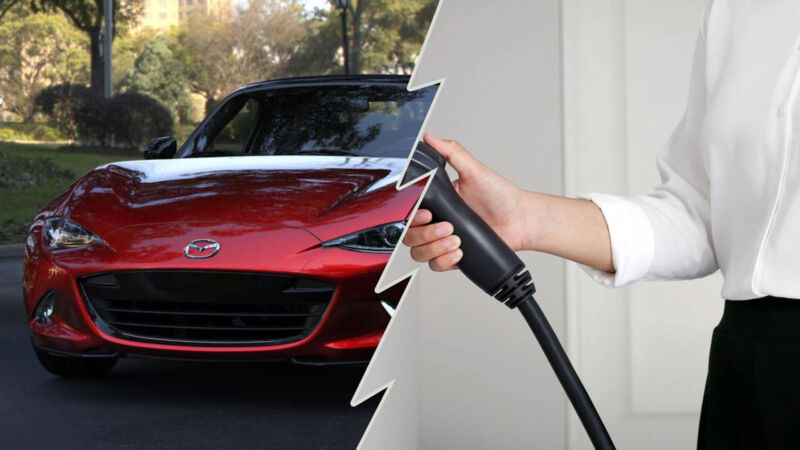 A red Miata with an ev charging plug photoshopped onto it