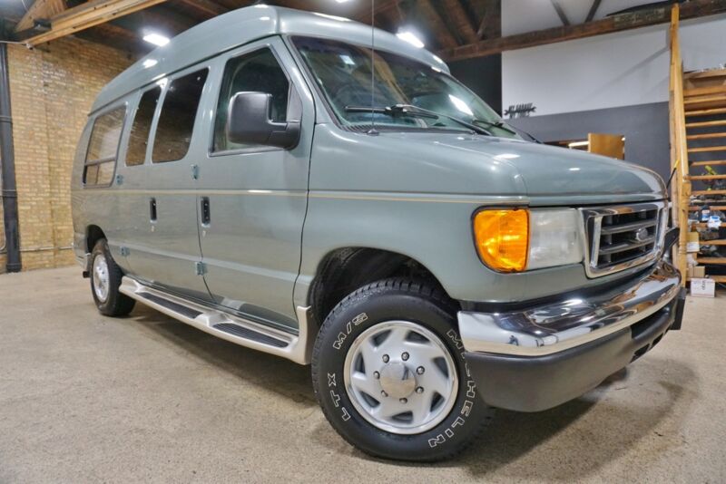 A grey Ford Econoline E-250 van