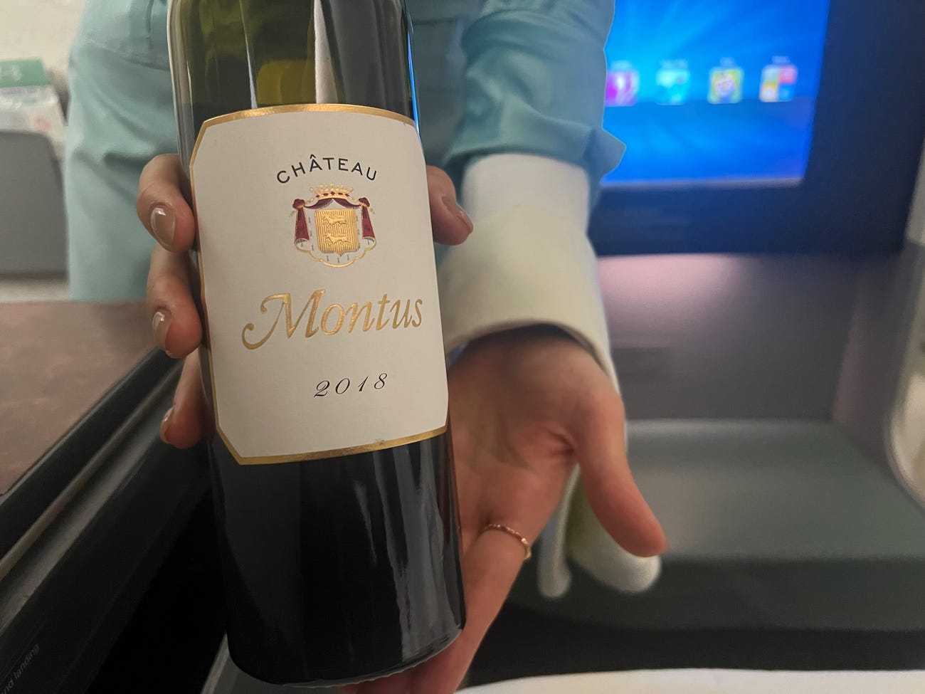 Red wine held by a flight attendant.