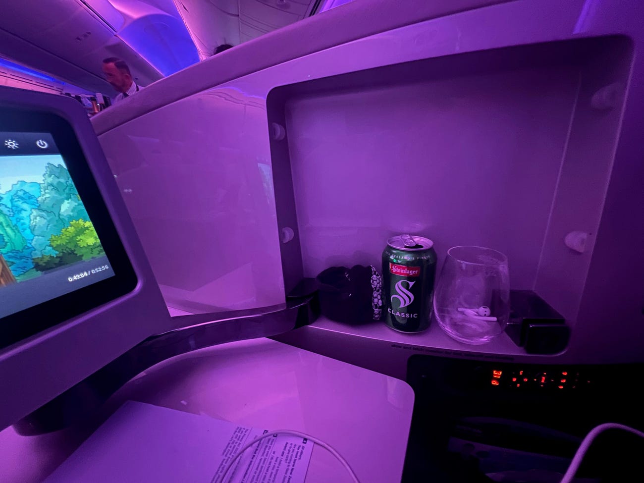 A business-class seat with a small shelf.