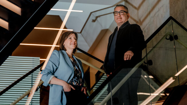 Morgan Flatley and Tariq Hassan standing on stairs