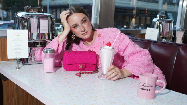 model sitting at booth at Chanel diner